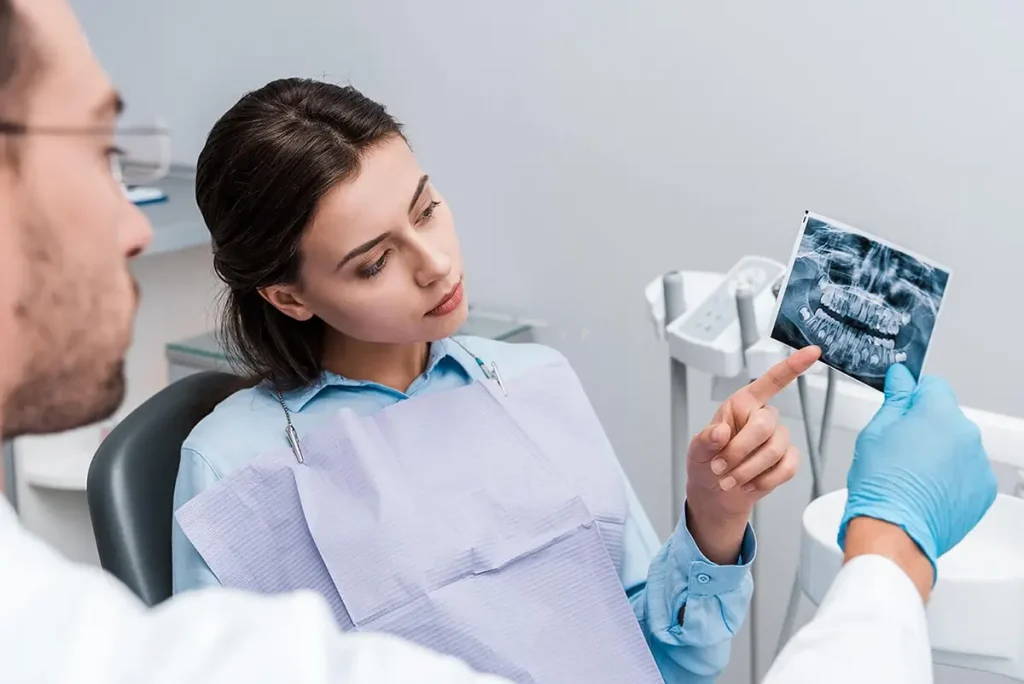 Dentist showing dental x-rays to a patient.
