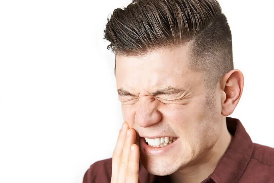 Man having a lot of tooth pain.